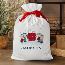 Bolsa de regalo extragrande de la pandilla de PEANUTS® y Snoopy para un día nevado