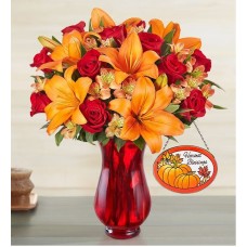 Elegante ramo de rosas y lirios de otoño (con jarrón rojo y atrapasoles)